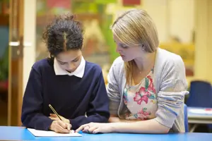 Teacher providing guidance to pupil