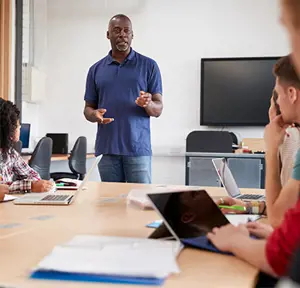 Male Teacher Teaching Children In Class ?? title