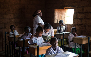 Teachers In Africa Helping Children In Class