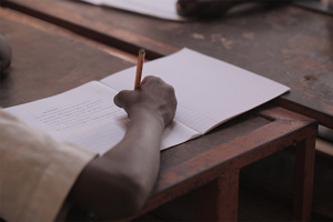 Boy Writing On Piece Paper ?? title