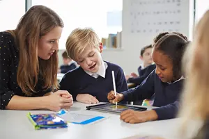 Female Primary Teacher With Two Pupils