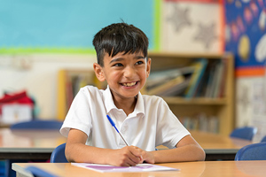 School Boy Happy And Writing